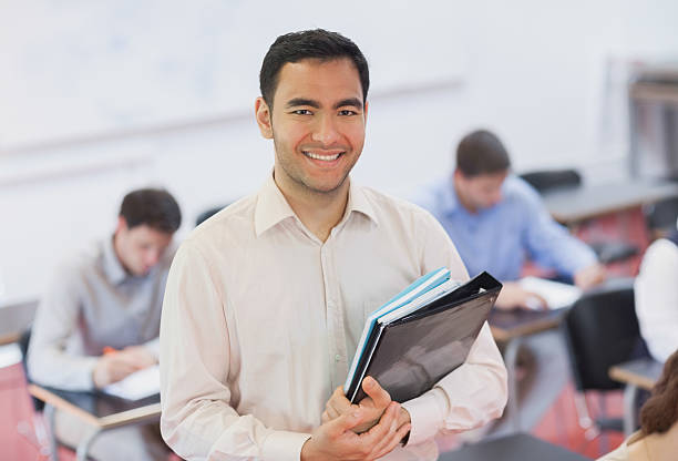 istock Portrait of handsome teacher posing in his classroom 511281863