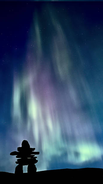 Inukshuk and Northern Lights stock photo