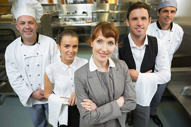istock Cute female manager posing with the staff 511284031