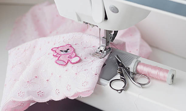 istock close up of sewing machine with pink material 511297956
