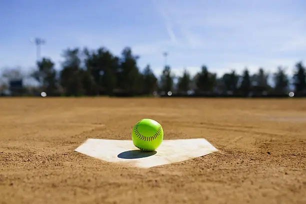 Baseball on a home plate in a baseball field in California mountains, Softball field