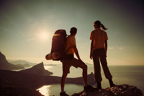istock Hikers looking at beautiful sunrise 511301274