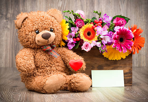 istock Bunch of flowers and a teddy bear 511303012