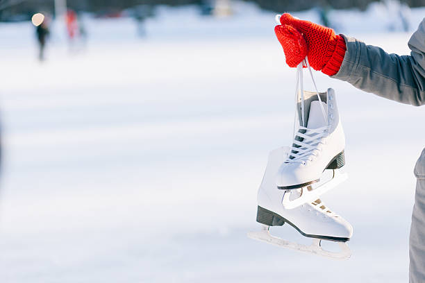 istock Young woman showing ice skates for winter 511303458