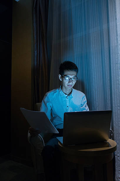 istock Businessman using laptop in hotel room 511305388