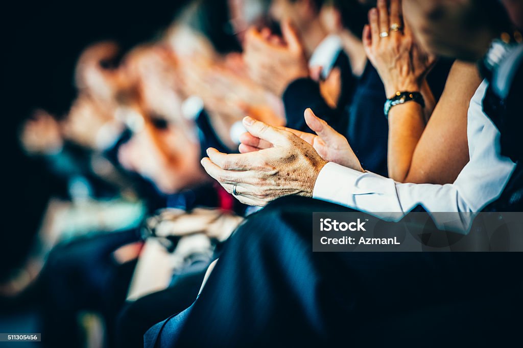 What a great speech! Group of businesspeople sitting in a row and applauding at seminar. Selective focus. Conference - Event Stock Photo