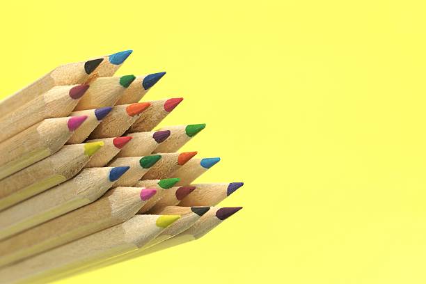 istock Large Group Of Colored Pencil Isolated On Yellow Background 511305560