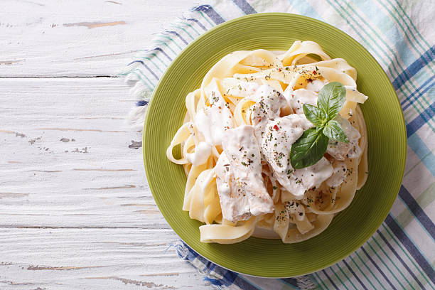 alfredo pasta in cream sauce with chicken. horizontal  top view