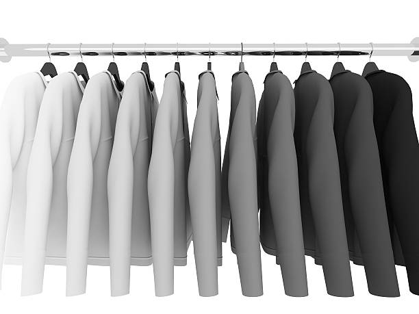 White smocks on wooden hangers hang in the cupboard of a laboratory, Black and white, bw