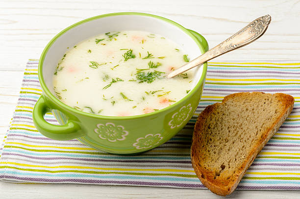 istock Cheese soup in green bowl on white wooden table. 511309816