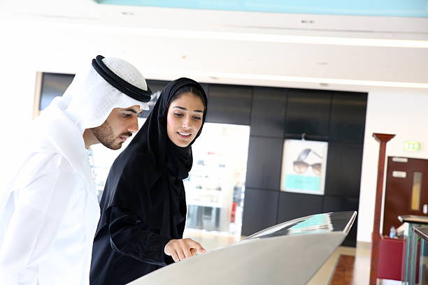 istock Arab family using interactive screen of digital kiosk. 511311130