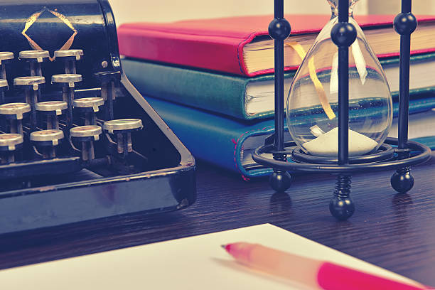 istock Hourglass, books and vintage typewriter 511311688