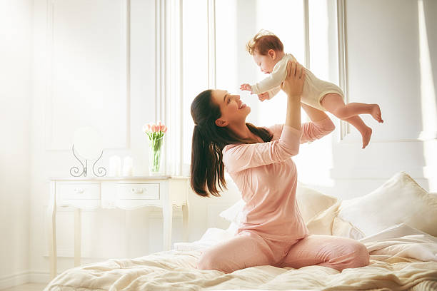 istock mother playing with her baby 511313390