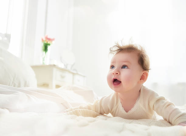 istock baby girl on the bed 511313452