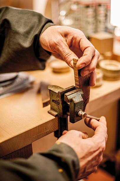 istock Craftsperson Adjusting Vice Tool and Piece of Wood in Workshop 511315356