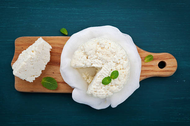 Homemade cottage cheese or curd, rustic style, top view Homemade cottage cheese or curd on wooden board, rustic style, top view ricotta photos stock pictures, royalty-free photos & images