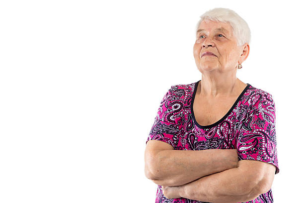 istock Elderly lady with arms crossed looking up 511316756