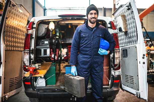 mechanic technician on a garage mechanic technician on a garage commercial land vehicle stock pictures, royalty-free photos & images
