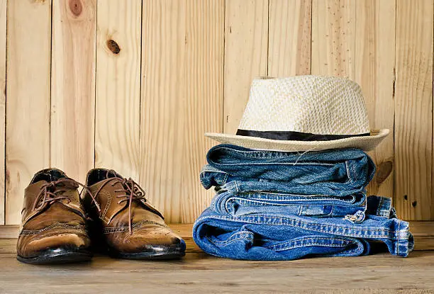 Travel,accessories, jeans, hats, shoes, ready for the trip on wooden backgrond