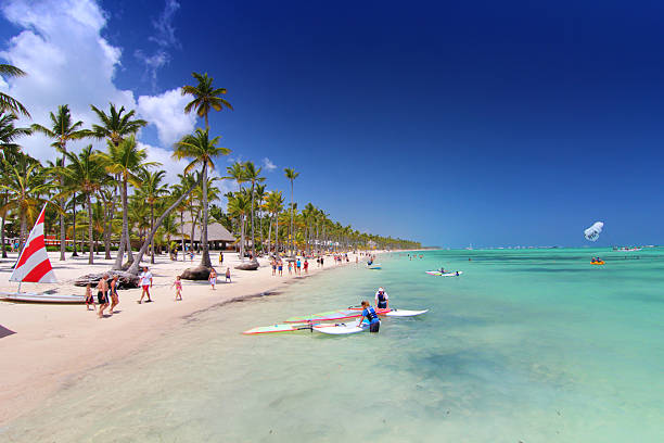 Playa Bavaro, Dominican Republic- April 19, 2015: Tourists on the on the longest beach in caribbean area preparing for water sport activities