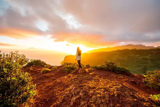 Beautiful landscape view near mirador de Abrante on La Gomera island with woman enjoying the sunrise.