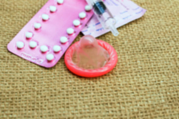 istock condom and birth control pills on wooden table background 511318698