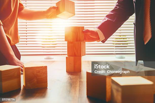 Two Business Persons Stock Photo - Download Image Now - Toy Block, Business, Teamwork