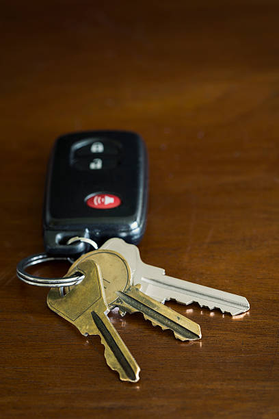 istock Key fob for a car and house keys on a table 511321845