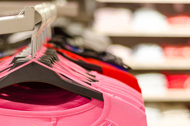 istock Blouses and shirts hooked on a rack in a boutique 511322184