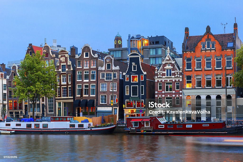 Night city view of Amsterdam canal with dutch houses Night city view of Amsterdam canal, typical dutch houses and boats, Holland, Netherlands. Amsterdam Stock Photo