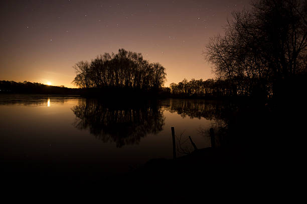 istock lake and stars at night 511325006