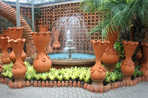 A fountain and pots in the Nong Nooch tropical botanic garden near Pattaya city in Thailand