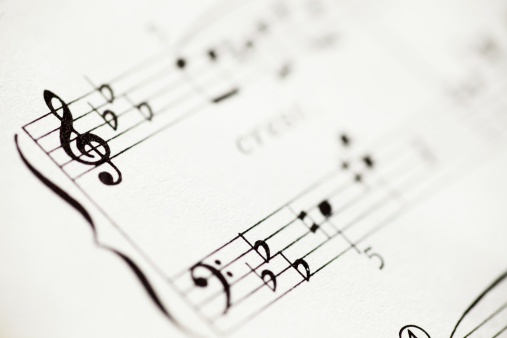 An extreme closeup of sheet music, captured with a shallow depth of field.