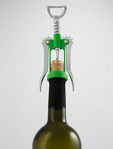 Green and chrome corkscrew wine opener with wine bottle Green and chrome corkscrew wine opener with wine bottle on white background cork puller stock pictures, royalty-free photos & images