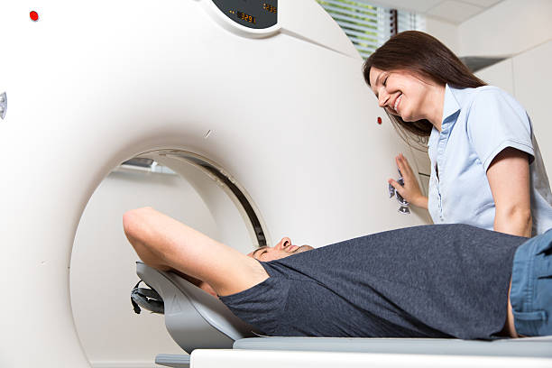 istock Medical technical assistant preparing scan of the spine with CT 511351347