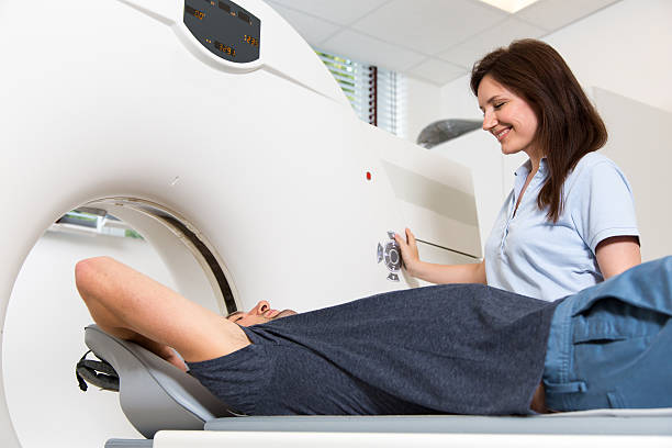 istock Medical technical assistant preparing scan of the spine with CT 511351369