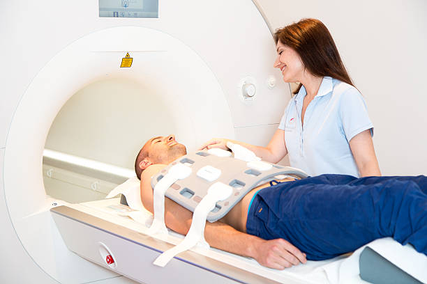 istock Medical technical assistant preparing scan of torso with MRI 511351515