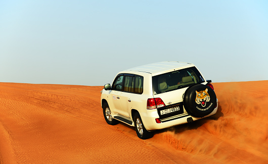 Dubai, UAE - September 12, 2013: The Dubai desert trip in off-road car is major tourists attraction in Dubai.