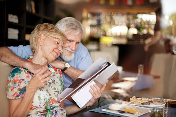 istock Happy Senior Couple Reading Magazine in Bar 511351967