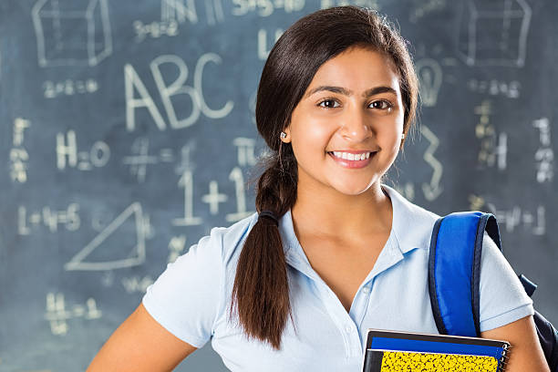 Portrait of pretty Indian high school student in classroom Portrait of pretty Indian high school student in classroom schoolgirl stock pictures, royalty-free photos & images