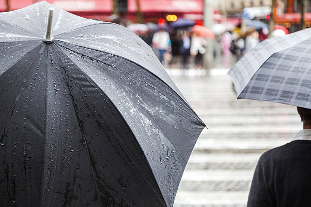 istock rain umbrellas in the city 511353227