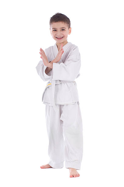 Young boy fighter in kimono taking pose stock photo