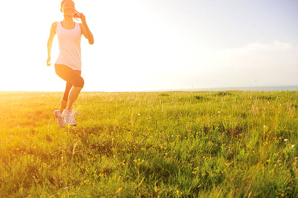 istock Runner athlete running on sunrise/sunset grass field 511354219