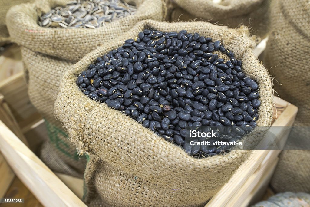 Pile of black bean in fabric sack Bag Stock Photo