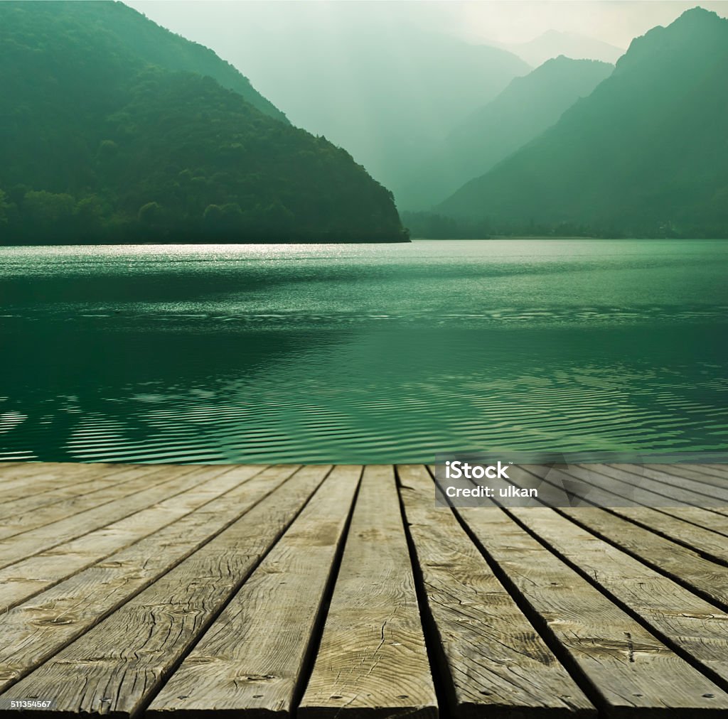 Mountain lake and flowing river with a wooden bridge Bridge - Built Structure Stock Photo