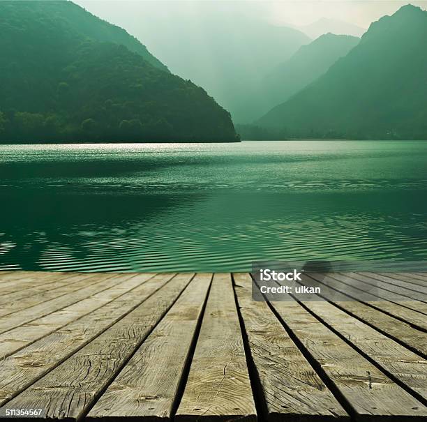 Mountain Lake And Flowing River With A Wooden Bridge Stock Photo - Download Image Now