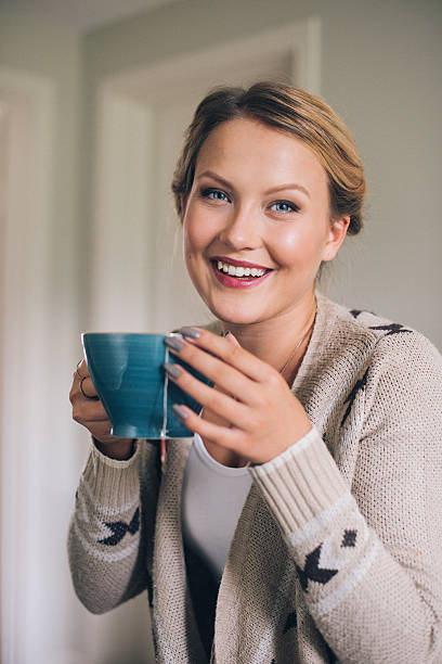 istock Woman having a cup of tea in her kitchen 511355687