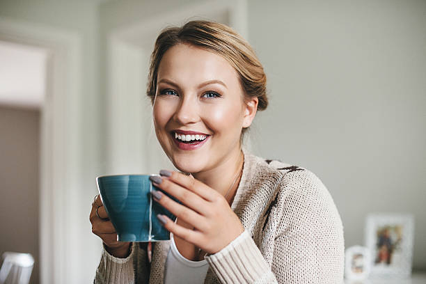 istock Woman having a cup of tea in her kitchen 511355717