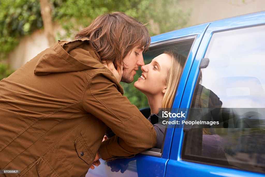 Lingering goodbyes A young couple kissing each other goodbye through a car windowhttp://195.154.178.81/DATA/shoots/ic_783794.jpg Adult Stock Photo