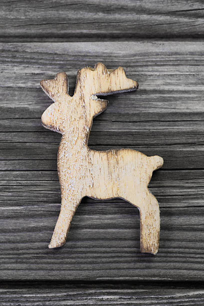istock Wooden reindeer figure on grey background for christmas. 511355837